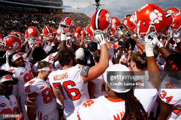 Players of the Clemson Tigers raise their helmets prior to their game against the Wake Forest Demon Deacons at Truist Field on September 24, 2022 in...