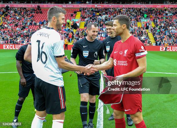 The Liverpool captain Xabi Alonso and Manchester United captain Michael Carrick exchange pennants at Anfield on September 24, 2022 in Liverpool,...
