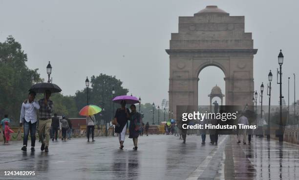 People enjoy rainy weather at Kartavya path, on September 24, 2022 in New Delhi, India.