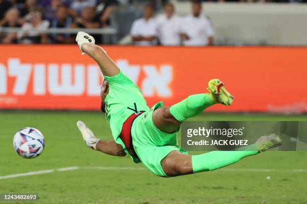 Albania's goalkeeper Thomas Strakosha dives to save a shot during the UEFA Nations League - League B Group 2 - football match between Israel and...