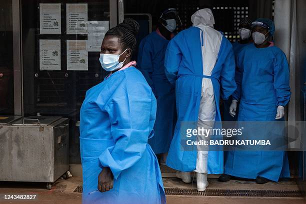 Members of the Ugandan Medical staff of the Ebola Treatment Unit stand inside the ward in Personal Protective Equipment at Mubende Regional Referral...