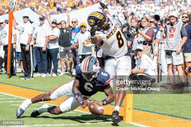 Linebacker Eugene Asante of the Auburn Tigers chases after the loose ball as running back Nathaniel Peat of the Missouri Tigers fumbles during the...