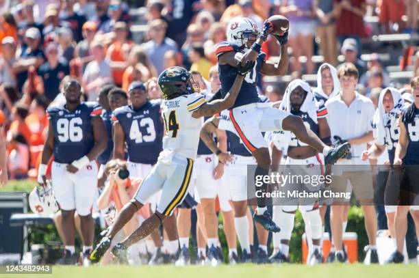 Wide receiver Koy Moore of the Auburn Tigers catches a pass in front of defensive back Kris Abrams-Draine of the Missouri Tigers during the second...