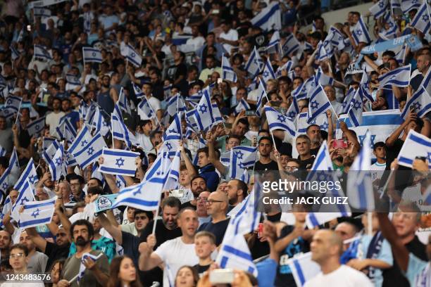 Israel supporters wave the national flag during the UEFA Nations League - League B Group 2 - football match between Israel and Albania at the at the...