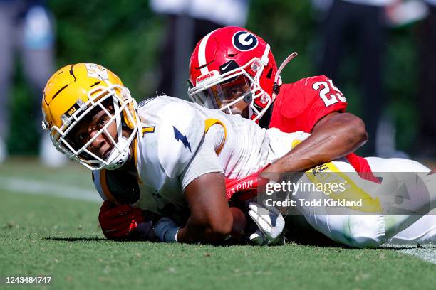 Marquez Cooper of the Kent State Golden Flashes rushes in for a touchdown as Christopher Smith of the Georgia Bulldogs defends the second half at...