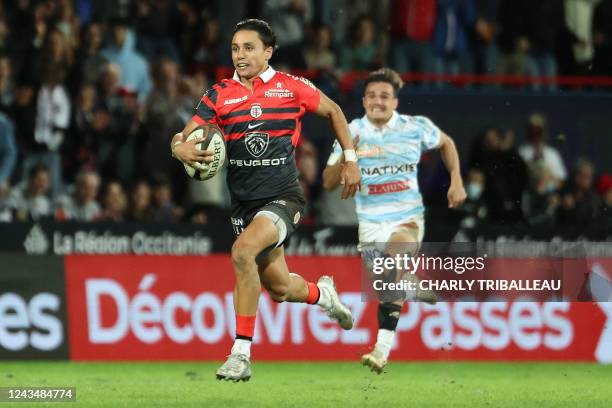 Toulouse's Italian fullback Ange Capuozzo runs to score a try during the French Top14 rugby union match between Stade Toulousain Rugby and Racing 92...