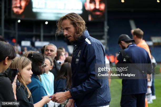 Jonas Olsson poses for selfies and signs autographs for fans after the match at The Hawthorns on September 24, 2022 in West Bromwich, England.