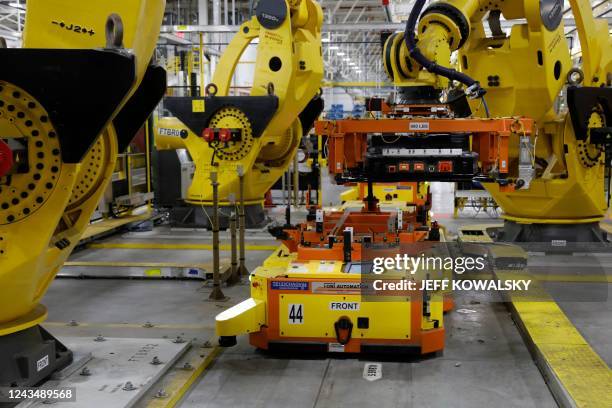 Robot lifts the battery as it is istalled on the frame of Ford Motor Co. Battery powered F-150 Lightning trucks under production at their Rouge...