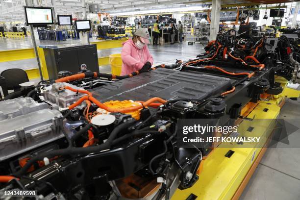 Worker checks the cables on the battery for Ford Motor Co. Battery powered F-150 Lightning trucks under production at their Rouge Electric Vehicle...