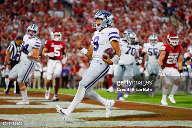 Quarterback Adrian Martinez of the Kansas State Wildcats scores a touchdown on a 6-yard keeper against the Oklahoma Sooners in the first quarter at...