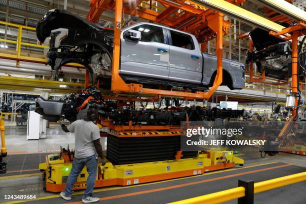 The truck cab is lowered on the frame of Ford Motor Co. Battery powered F-150 Lightning trucks under production at their Rouge Electric Vehicle...