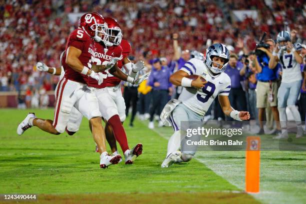 Quarterback Adrian Martinez of the Kansas State Wildcats slides down at the four-yard line rather than score the winning touchdown on a 55-yard run...