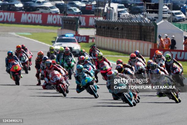 Moto3 riders, including pole sitter Leopard Racing rider Tatsuki Suzuki of Japan start the Moto3 race during the MotoGP Japanese Grand Prix at the...