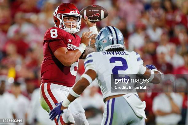 Quarterback Dillon Gabriel of the Oklahoma Sooners throws a one-yard touchdown pass before getting hit hard by Kobe Savage of the Kansas State...