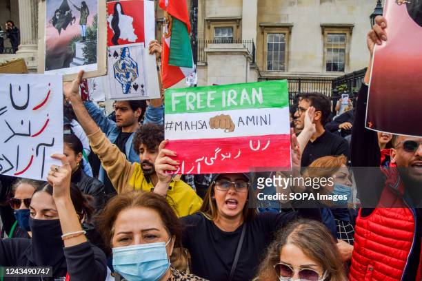 Protester holds a "Free Iran" placard during the demonstration. Thousands of Iranians and other protesters gathered in Trafalgar Square in response...