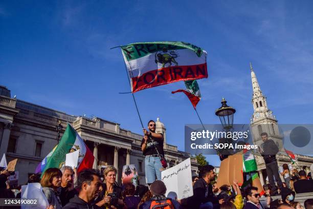 Protester waves a "Freedom for Iran" flag during the demonstration. Thousands of Iranians and other protesters gathered in Trafalgar Square in...