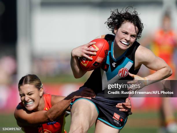 Ebony O'Dea of the Power is tackled by Lauren Bella of the Suns during the 2022 S7 AFLW Round 05 match between the Gold Coast Suns and the Port...