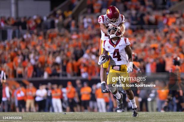 USCs Travis Dye celebrates with Max Williams after an interception in the fourth quarter of the college football game between the USC Trojans and the...