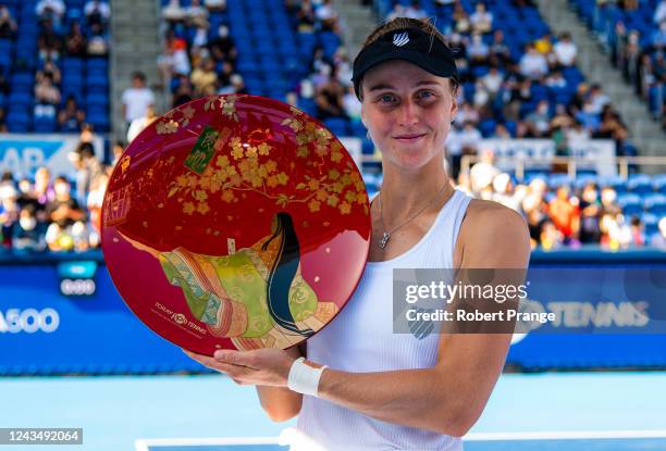 Liudmila Samsonova of Russia poses with the champions trophy after defeating Qinwen Zheng of China in the final match on Day 7 of the Toray Pan...