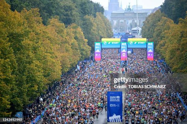 Athletes take the start of the Berlin Marathon race on September 25, 2022 close to the Brandenburg Gate in Berlin. - The course record was set by...