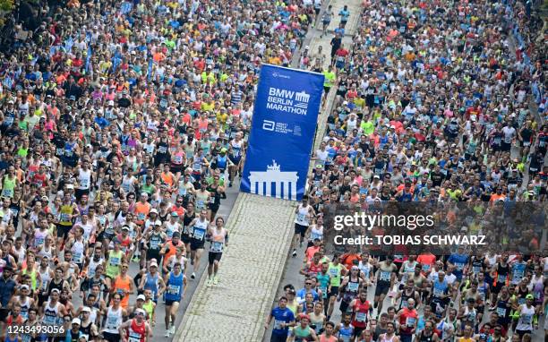 Athletes take part in the Berlin Marathon race on September 25, 2022 in Berlin. - The course record was set by Kenyan long distance star Eliud...