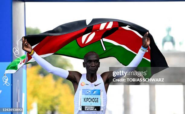 Kenya's Eliud Kipchoge crosses the finish line to win the Berlin Marathon race on September 25, 2022 in Berlin. - Kipchoge has beaten his own world...