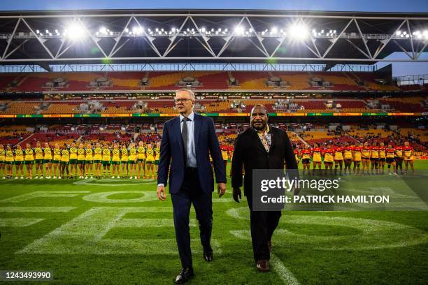 Australia's Prime Minister Anthony Albanese and Papua New Guinea's Prime Minister James Marape walk on the field before the international women's...