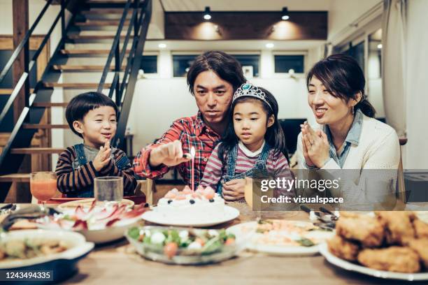 father lighting the birthday candle - boy tiara stock pictures, royalty-free photos & images