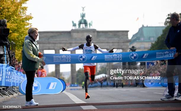 Kenya's Eliud Kipchoge crosses the finish line to win the Berlin Marathon race on September 25, 2022 in Berlin. - Kipchoge has beaten his own world...