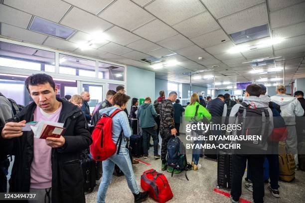 People arriving from Russia wait at the Mongolian border checkpoint of Altanbulag on September 25 after the Kremlin announced a partial mobilisation...