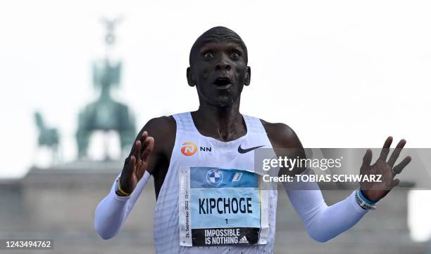 Kenya's Eliud Kipchoge crosses the finish line to win the Berlin Marathon race on September 25, 2022 in Berlin. - Kipchoge has beaten his own world...