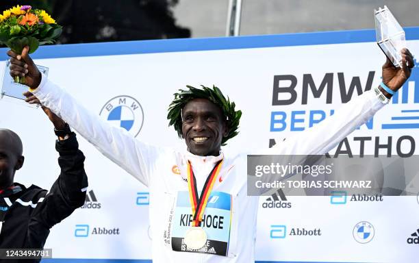 Kenya's Eliud Kipchoge celebrates on the podium after winning the Berlin Marathon race on September 25, 2022 in Berlin. - Kipchoge has beaten his own...