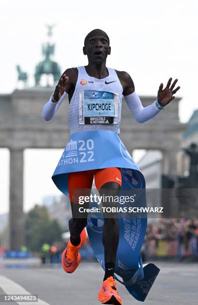 Kenya's Eliud Kipchoge crosses the finish line to win the Berlin Marathon race on September 25, 2022 in Berlin. - Kipchoge has beaten his own world...