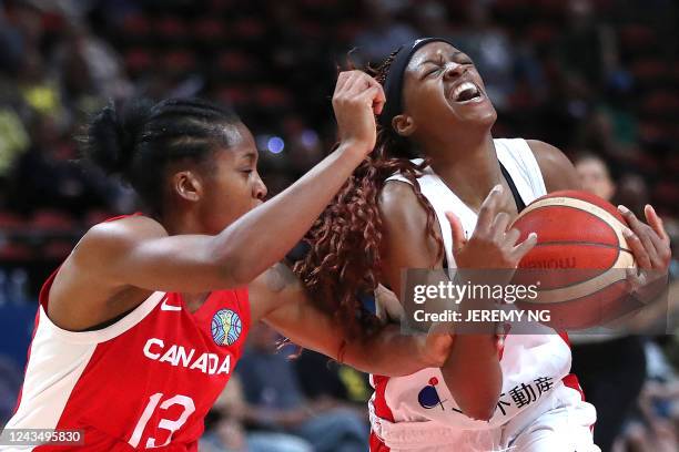 Japan's Stephanie Mawuli and Canada's Shay Colley challenge for the ball during the Women's Basketball World Cup group B game between Japan and...