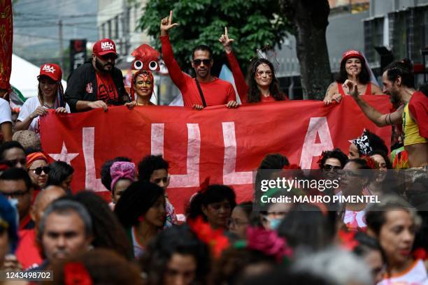 Supporters of the Brazilian presidential candidate for the leftist Workers Party and former President , Luiz Inacio Lula da Silva, flash the L sign...