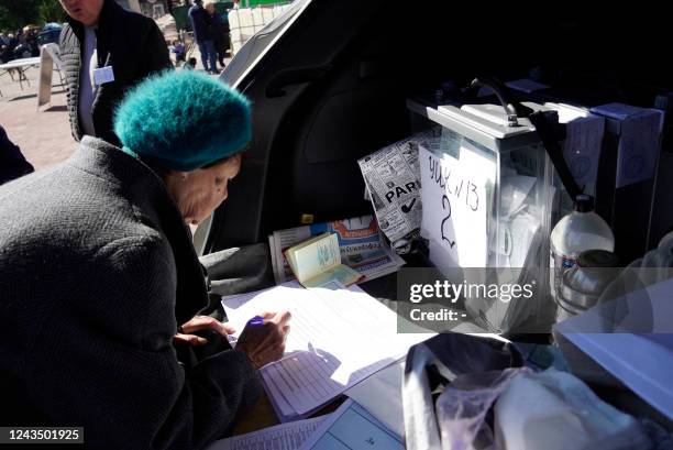 Woman attends a referendum at a mobile voting station in Mariupol on September 25, 2022. - Western nations dismissed the referendums in...