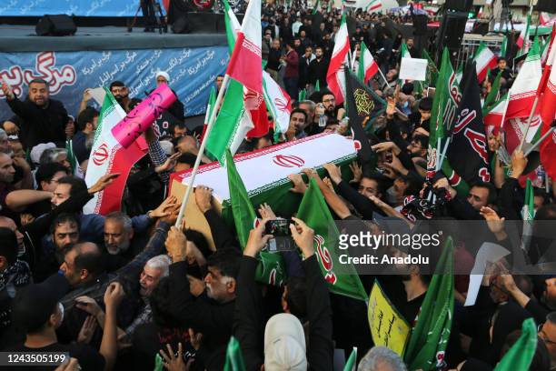 People carry the coffin of Hossein Taghipour, a member of the paramilitary Basij force who was killed in ongoing protests erupted over the death of...