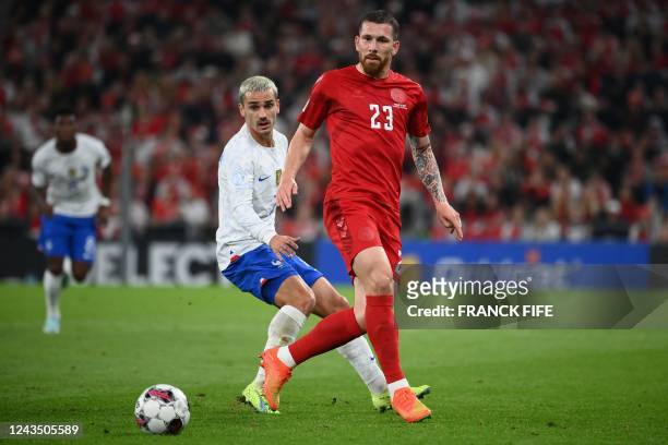 Denmark's midfielder Pierre-Emile Hojbjerg and France's forward Antoine Griezmann vie for the ball during the UEFA Nations League football match...