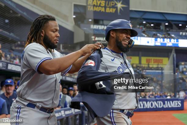 Vladimir Guerrero Jr. #27 of the Toronto Blue Jays puts the home run jacket on Teoscar Hernandez in the eighth inning against the Tampa Bay Rays...