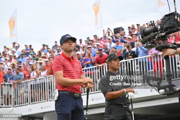 Sam Burns of the United States Team and Hideki Matsuyama of Japan and the International Team on the first tee during the final round Sunday singles...