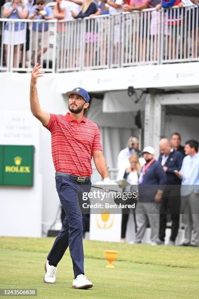 Team player Max Homa interacts with the crowd on the first tee during the final round Sunday singles matches of Presidents Cup at Quail Hollow...