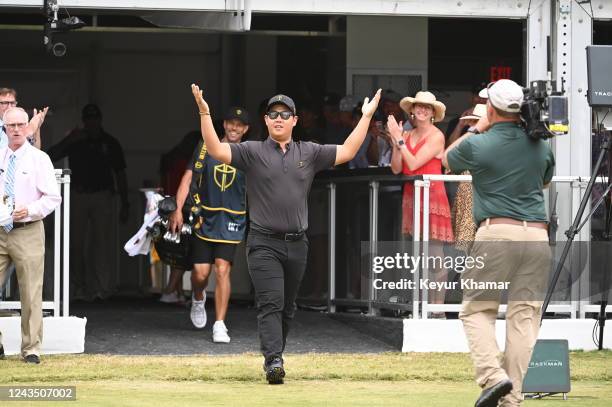 International Team Member Tom Kim of South Korea asks the crowd for noise as he arrives on the first tee during the final round Sunday singles...