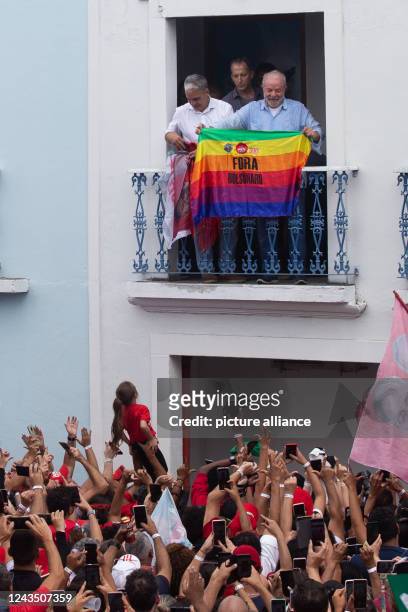 September 2022, Brazil, Rio de Janeiro: Brazilian Workers' Party presidential candidate ex-President Luiz Inacio Lula da Silva holds a flag reading...