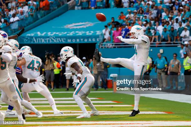 Miami Dolphins punter Thomas Morstead punts the ball off the backside of Miami Dolphins wide receiver Trent Sherfield for a safety during the game...