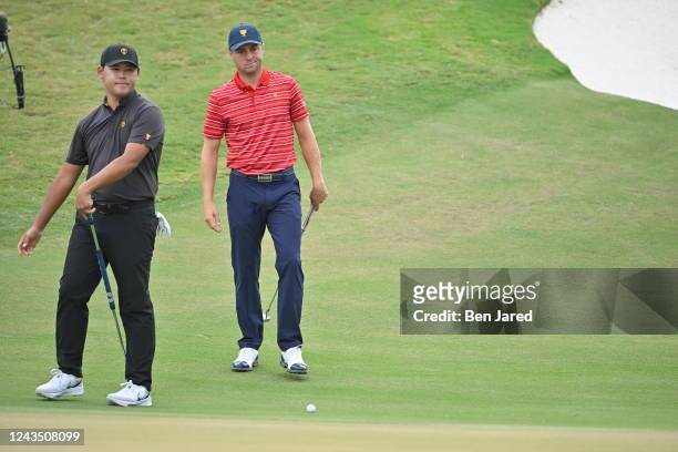 United States Team Member Justin Thomas, R, watches International Team Member Si Woo Kim of South Koreas putt on the 12th hole during the final round...
