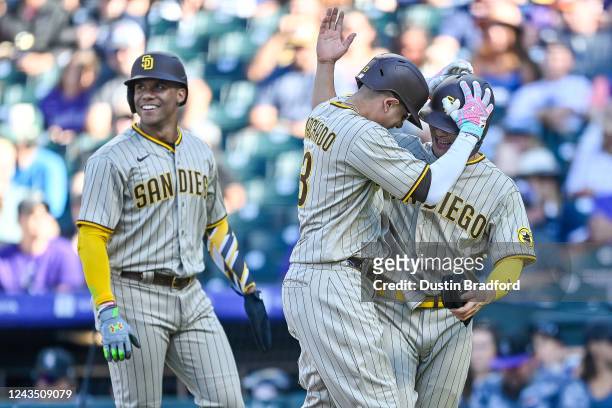 Manny Machado of the San Diego Padres celebrates with Ha-Seong Kim and Juan Soto after hitting an eighth inning three run home run against the...