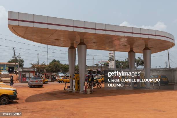 This photograph taken on August 20, 2022 in Yaounde, Cameroon, shows a petrol station. A vintage pump in the Vietnamese hills; a Madrid petrol...