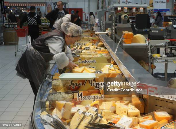 Seller puts cheese at the counter at the Auchan store September 25, 2022 in Moscow, Russia.