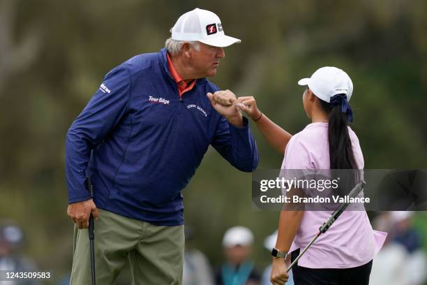 Ken Duke is congratulated by junior Kristina Ma on the first hole during the Final Round of the PURE Insurance Championship at Pebble Beach Golf...