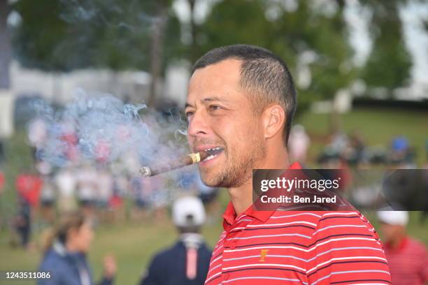 Xander Schauffele of the United States Team celebrates after defeating the International Team to take home the Presidents Cup Trophy during the final...